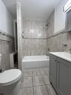 a bathroom with a bathtub toilet and sink