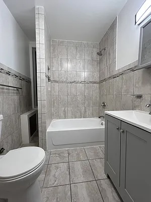 237 West 135th Street, Unit 3A Manhattan, NY 10030 - Photo 11 of 12 a bathroom with a bathtub toilet and sink