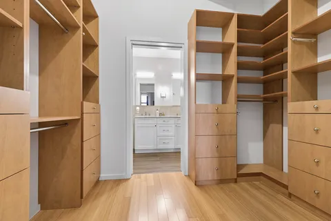a view of walk in closet with empty racks