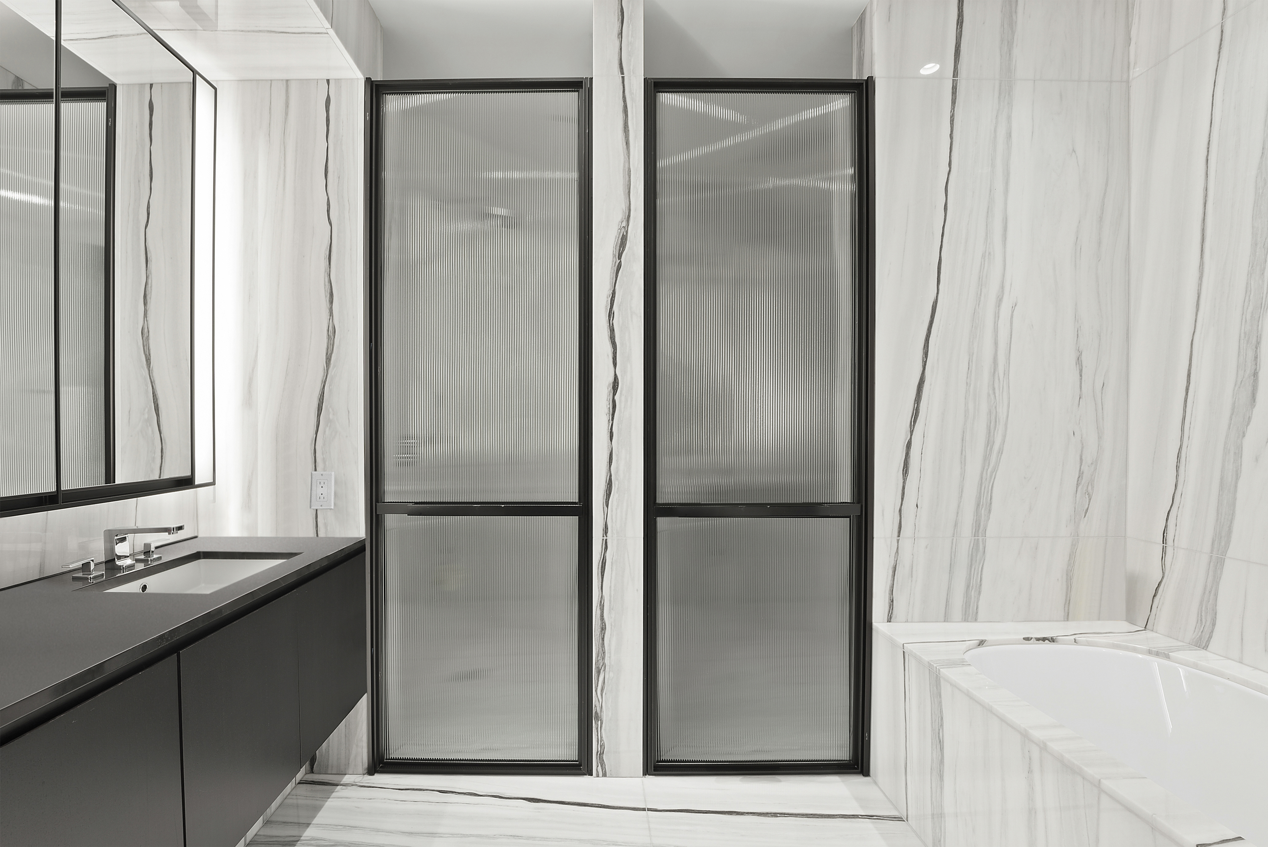 157 West 57th Street, Unit 49B Manhattan, NY 10019 - Photo 5 of 9 a bathroom with a bathtub and a sink