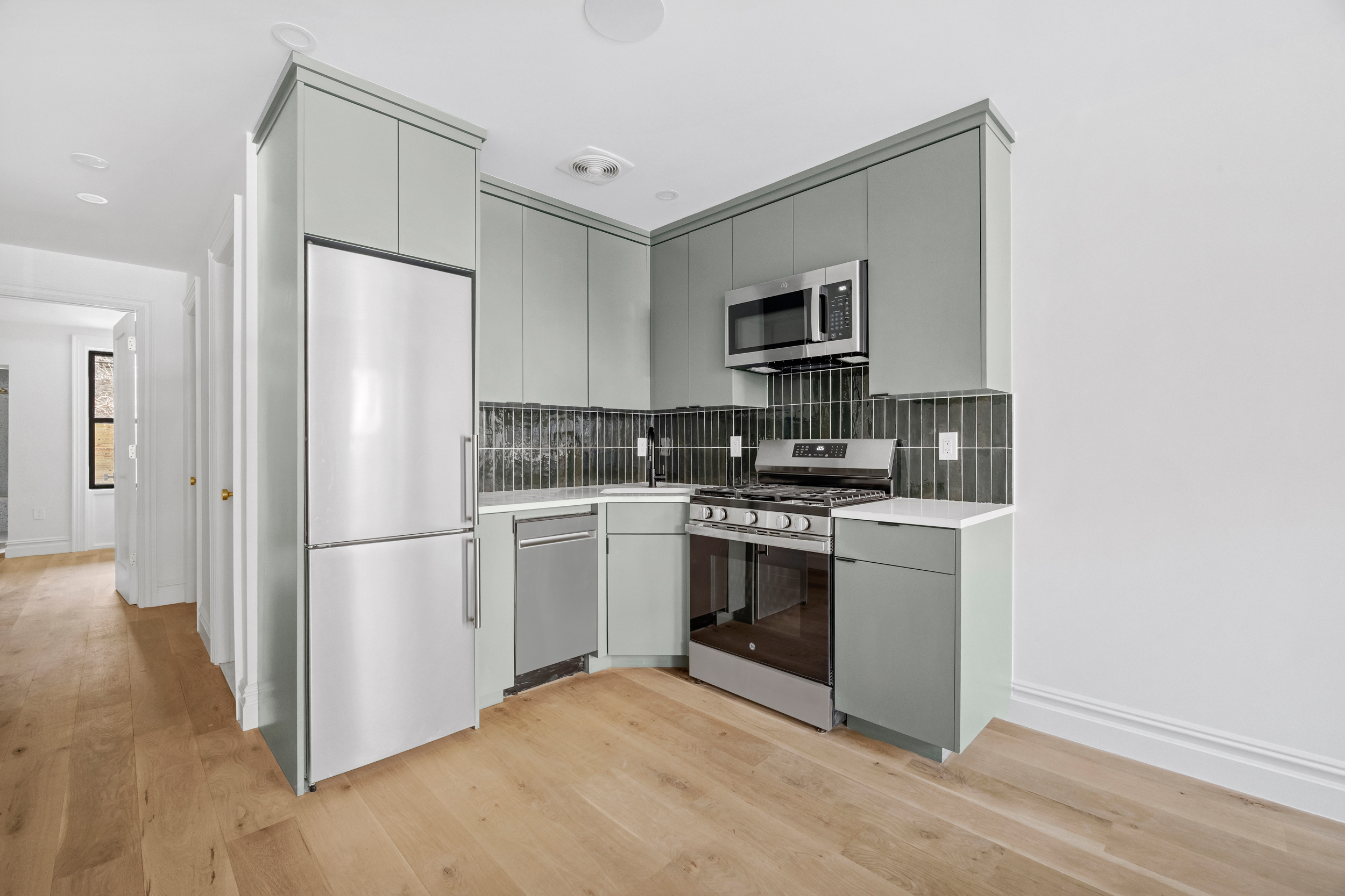 544 Madison Street, Unit A Brooklyn, NY 11221 - Photo 8 of 17 a kitchen with a refrigerator stove and microwave