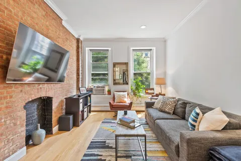 a living room with fireplace furniture and a flat screen tv