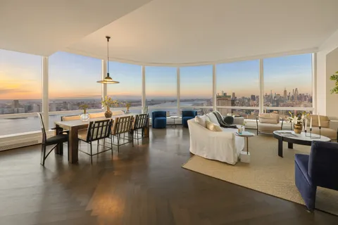 a dining room with furniture window and wooden floor