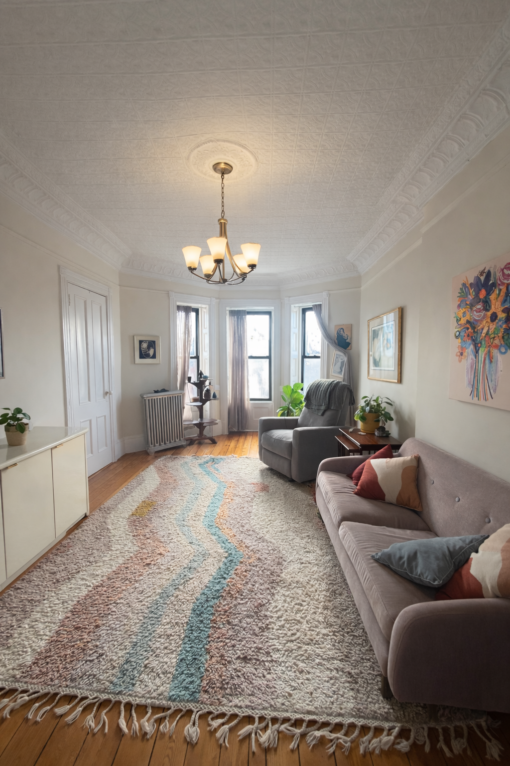 a living room with furniture and a chandelier