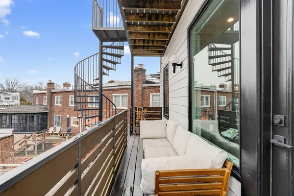 a view of a house with a balcony and stairs