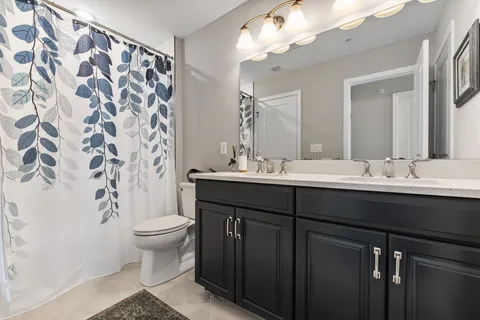a bathroom with a sink toilet and a mirror