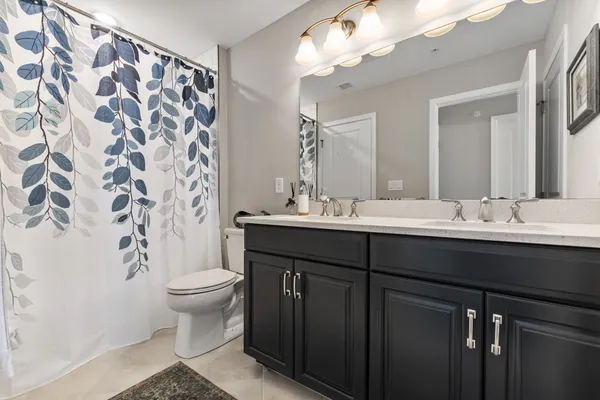 a bathroom with a sink toilet and a mirror