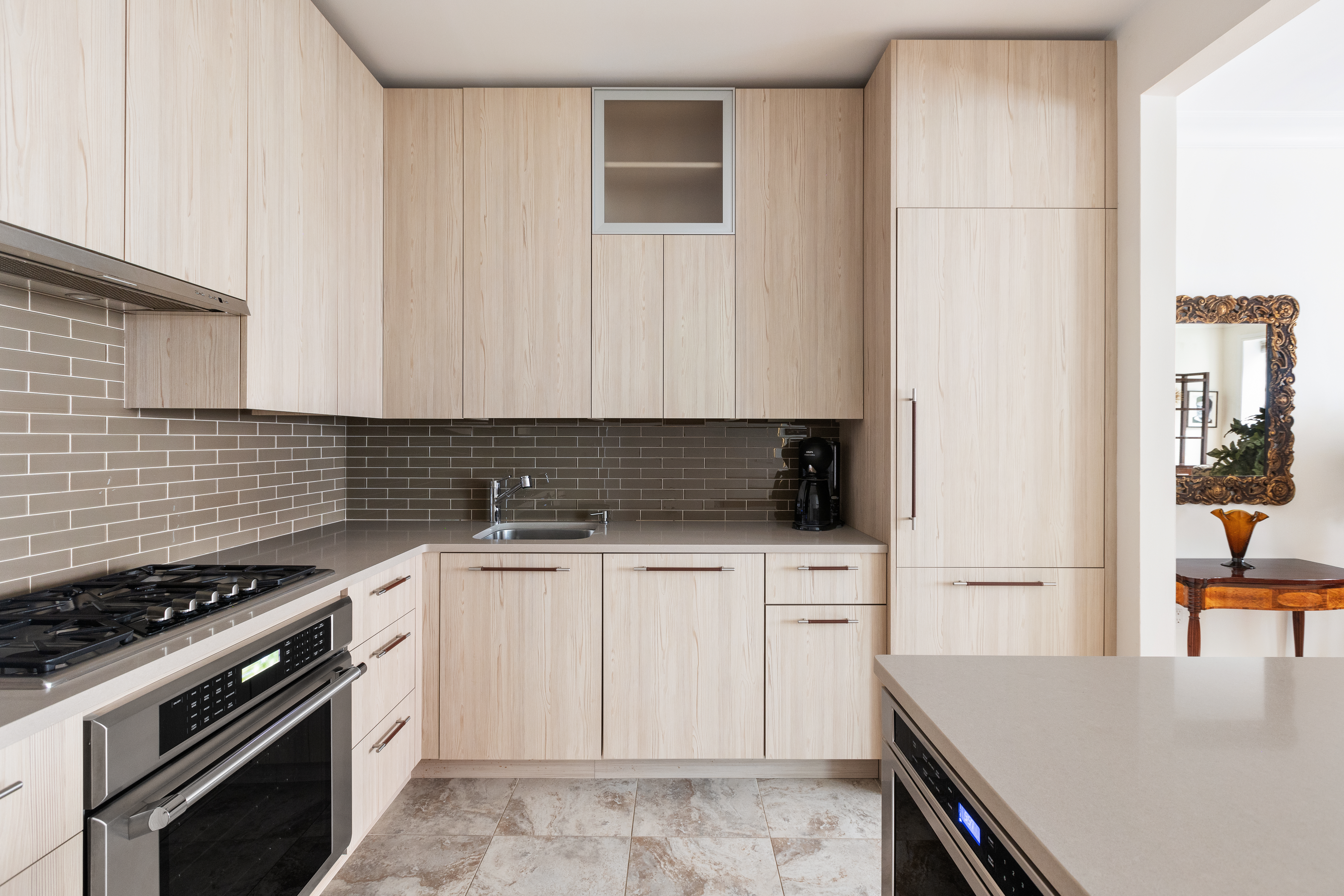 203 East 7th Street, Unit 2 Manhattan, NY 10009 - Photo 5 of 9 a kitchen with cabinets appliances and wooden floor