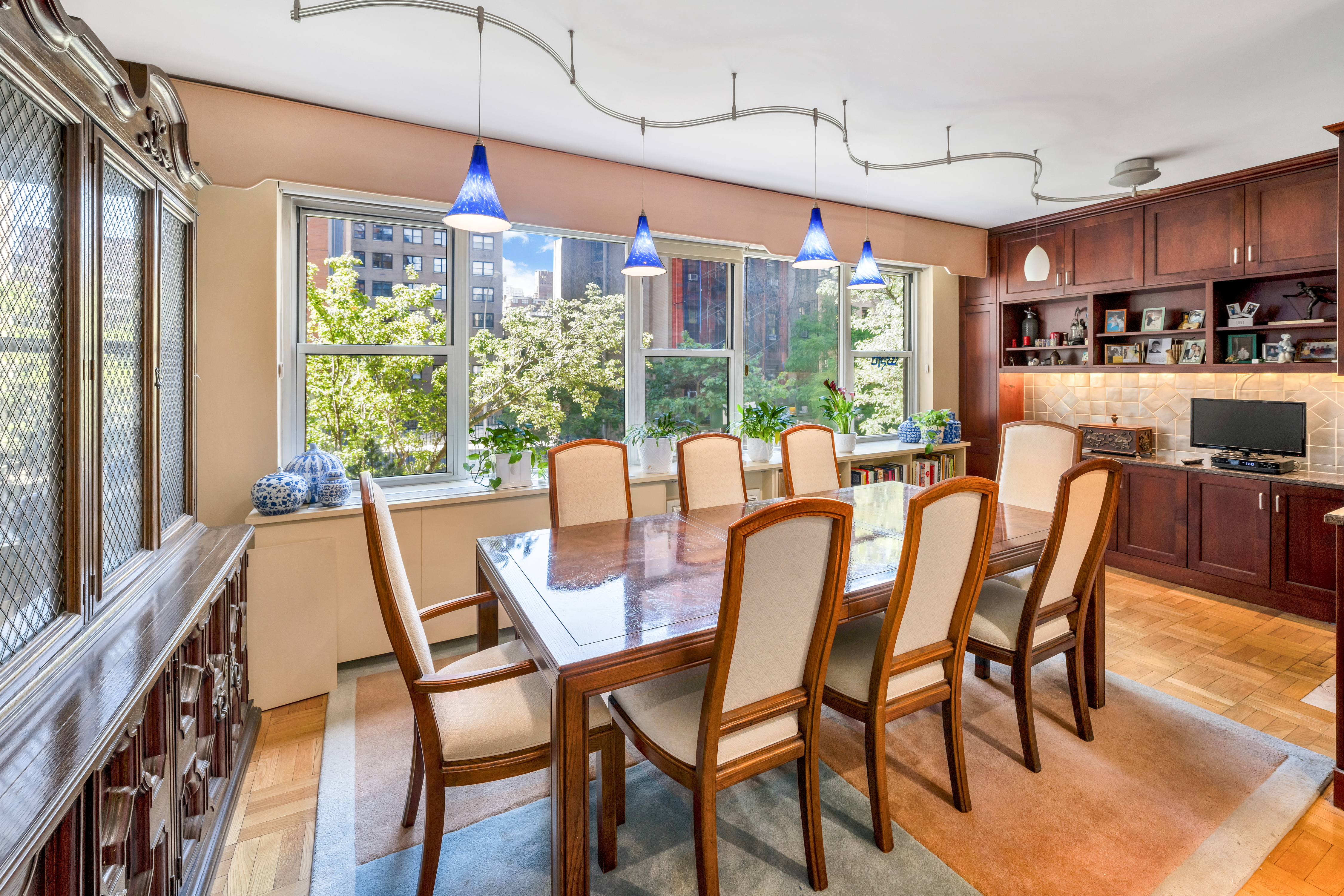 80 East End Avenue, Unit 3HJ Manhattan, NY 10028 - Photo 4 of 17 a dining room with furniture a chandelier and wooden floor
