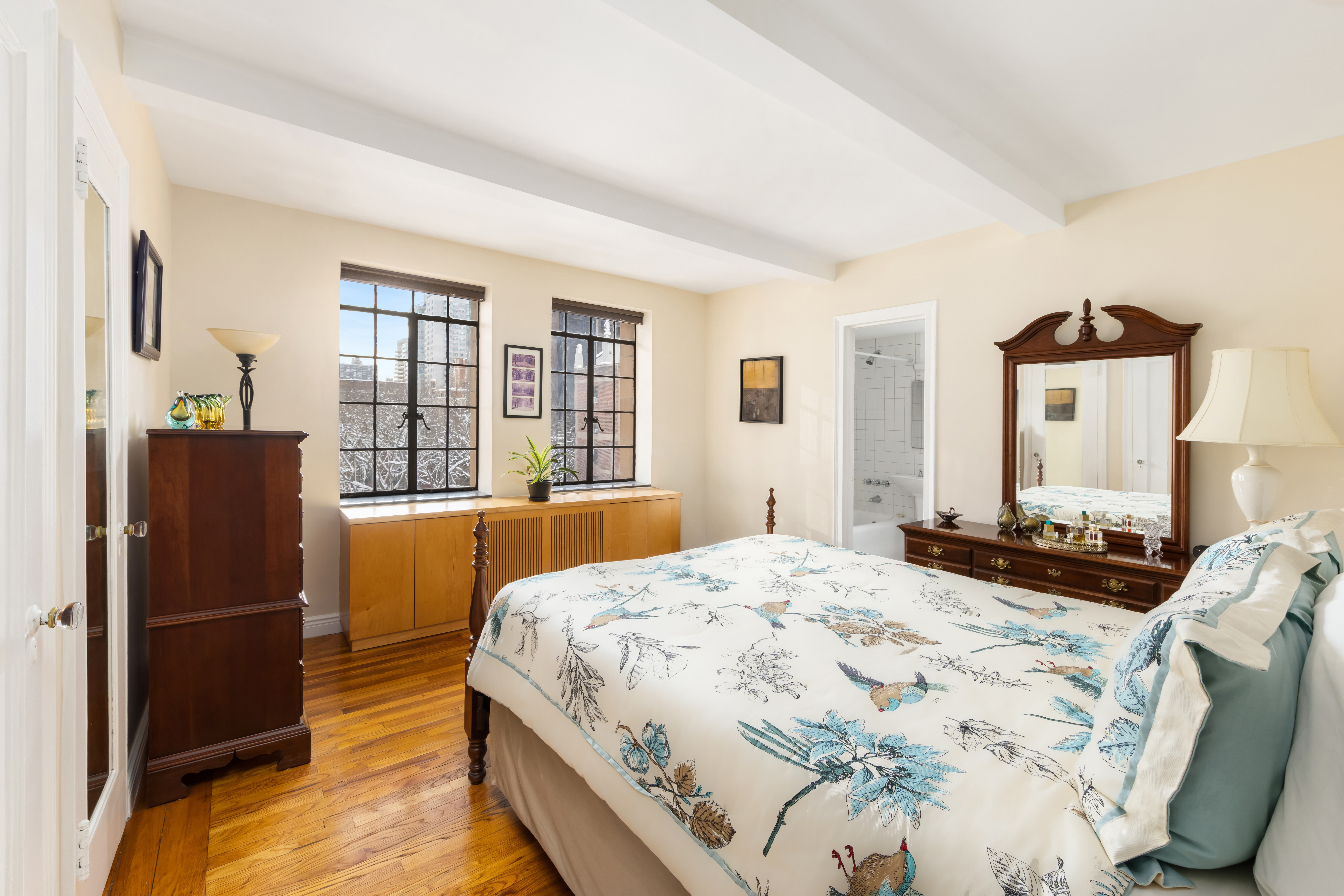 333 East 43rd Street, Unit 906 Manhattan, NY 10017 - Photo 7 of 17 a bedroom with a bed dresser and a large window