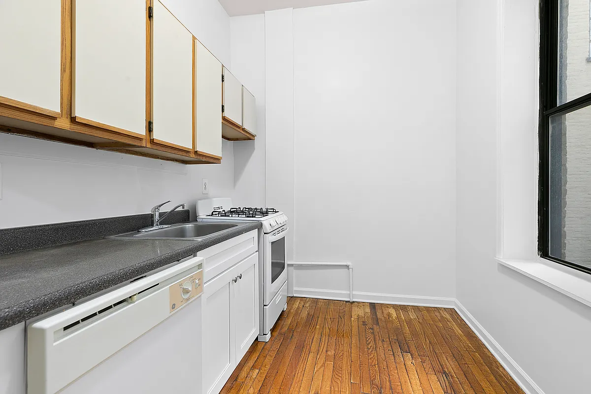 260 Gates Avenue, Unit 1C Brooklyn, NY 11238 - Photo 3 of 8 a kitchen with a sink cabinets and a wooden floor
