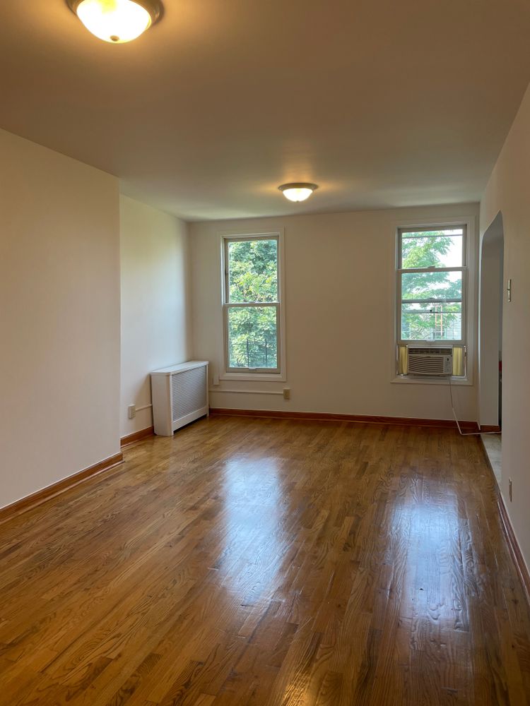 250 19th Street, Unit 3A Brooklyn, NY 11215 - Photo 2 of 15 an empty room with wooden floor and windows