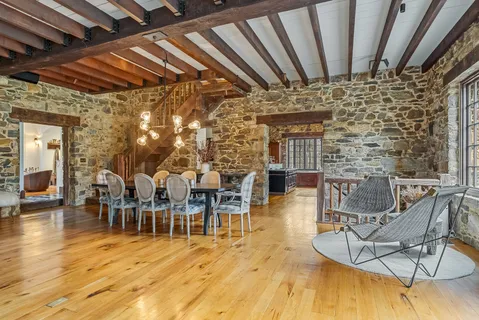 a dining room with furniture window and wooden floor