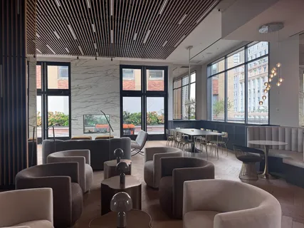 a living room with furniture and floor to ceiling windows