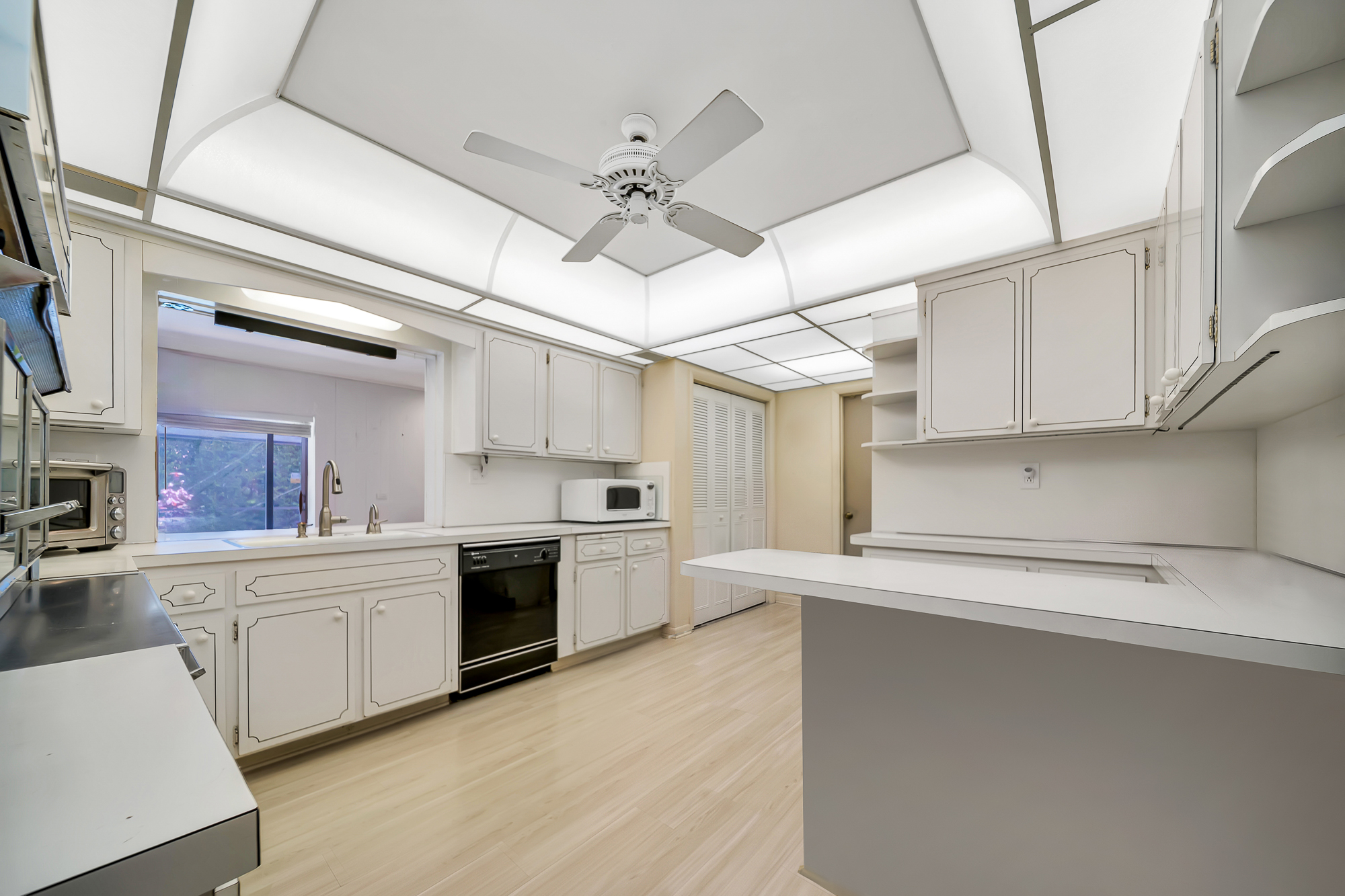 6760 Southwest 62nd Terrace Miami, FL 33143 - Photo 12 of 38 a kitchen with cabinets a sink and appliances