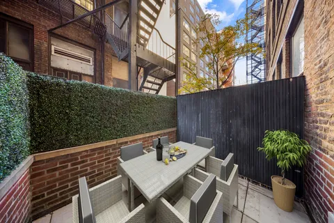 a backyard of a house with table and chairs
