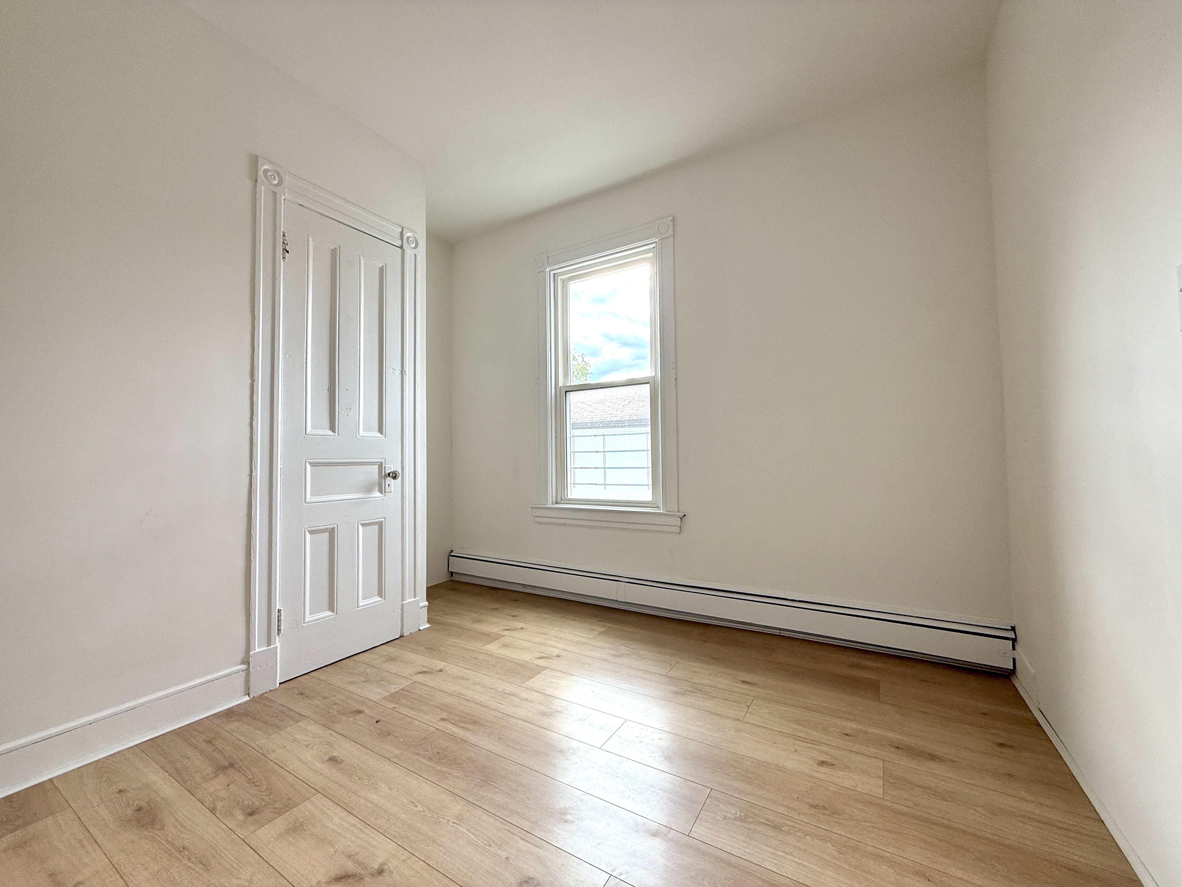 31 Seeley Street, Unit Undisclosed Brooklyn, NY 11218 - Photo 19 of 31 an empty room with wooden floor and windows