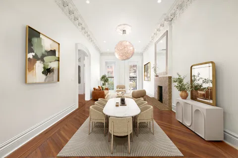 a dining room with wooden floor a glass table and chairs
