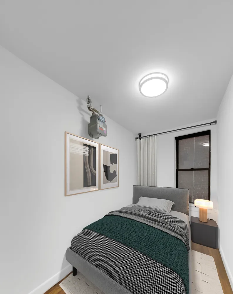 a bedroom with a bed lamp and a window