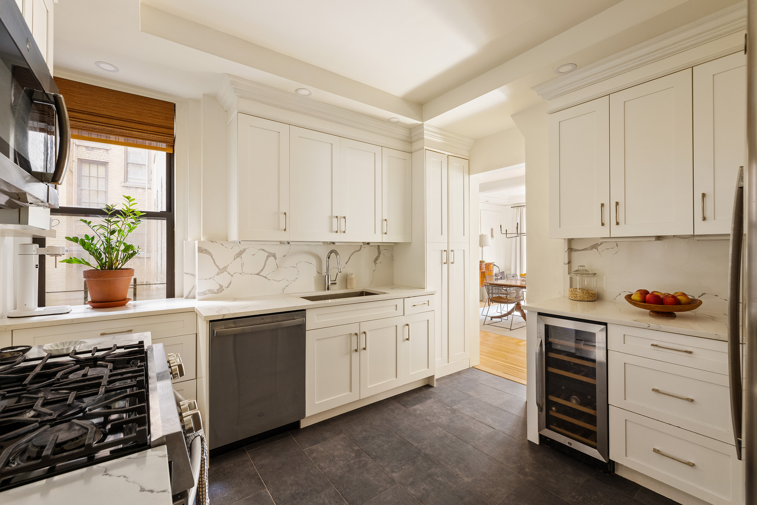 114 East 84th Street, Unit 3C Manhattan, NY 10028 - Photo 5 of 15 a kitchen with granite countertop white cabinets and white appliances