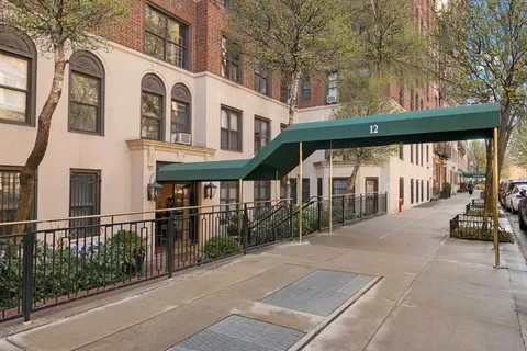 a view of a white building among the street