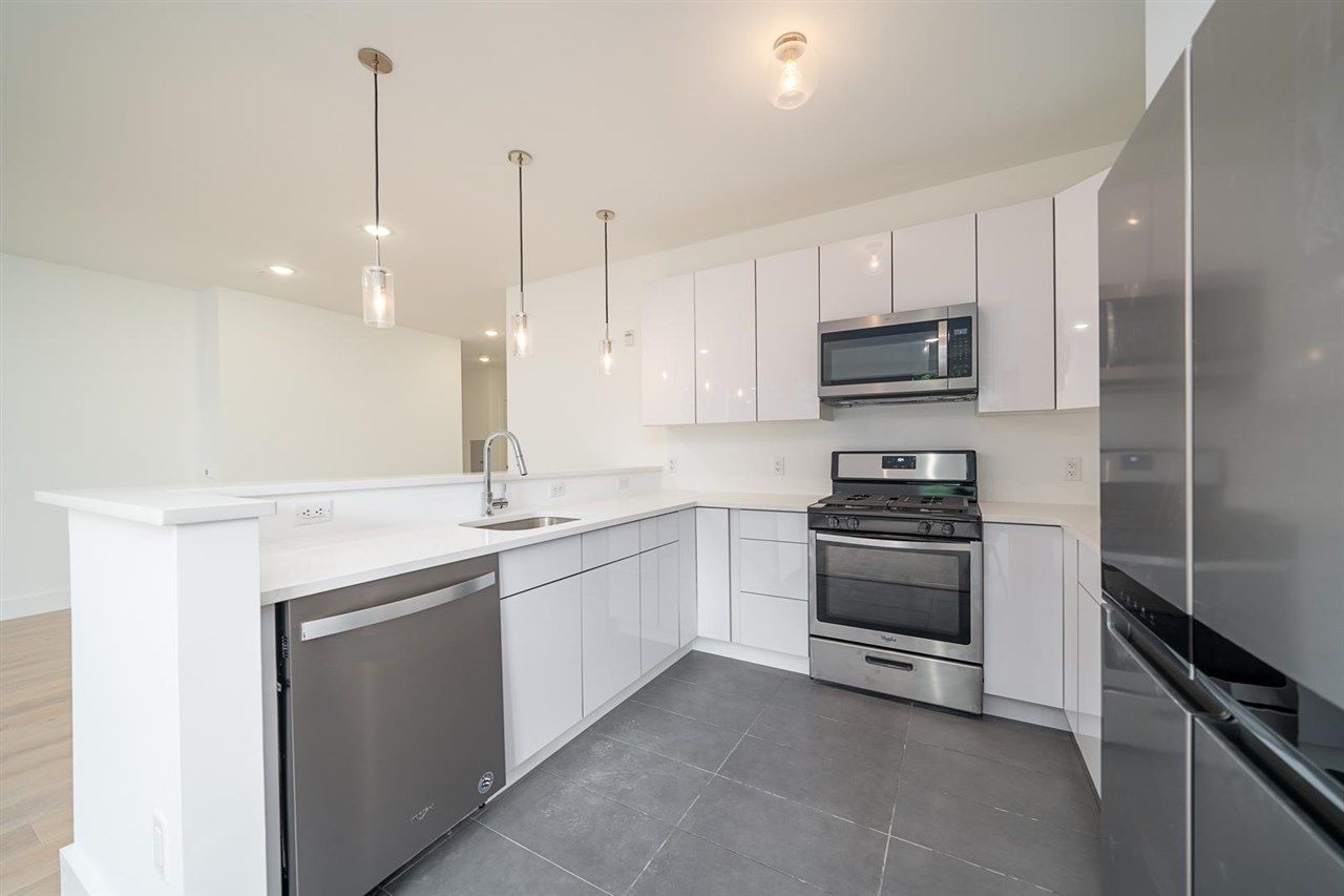 8621 River Road, Unit 6D North Bergen, NJ 07047 - Photo 3 of 36 a kitchen with stainless steel appliances granite countertop a sink and a stove