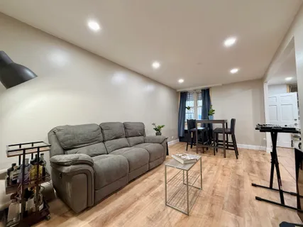 a living room with furniture and kitchen view