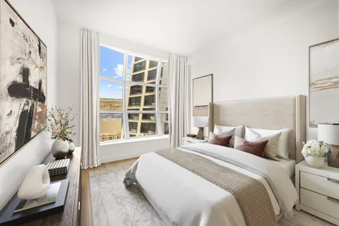 a bedroom with a bed and a couch