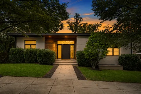 a front view of a house with garden
