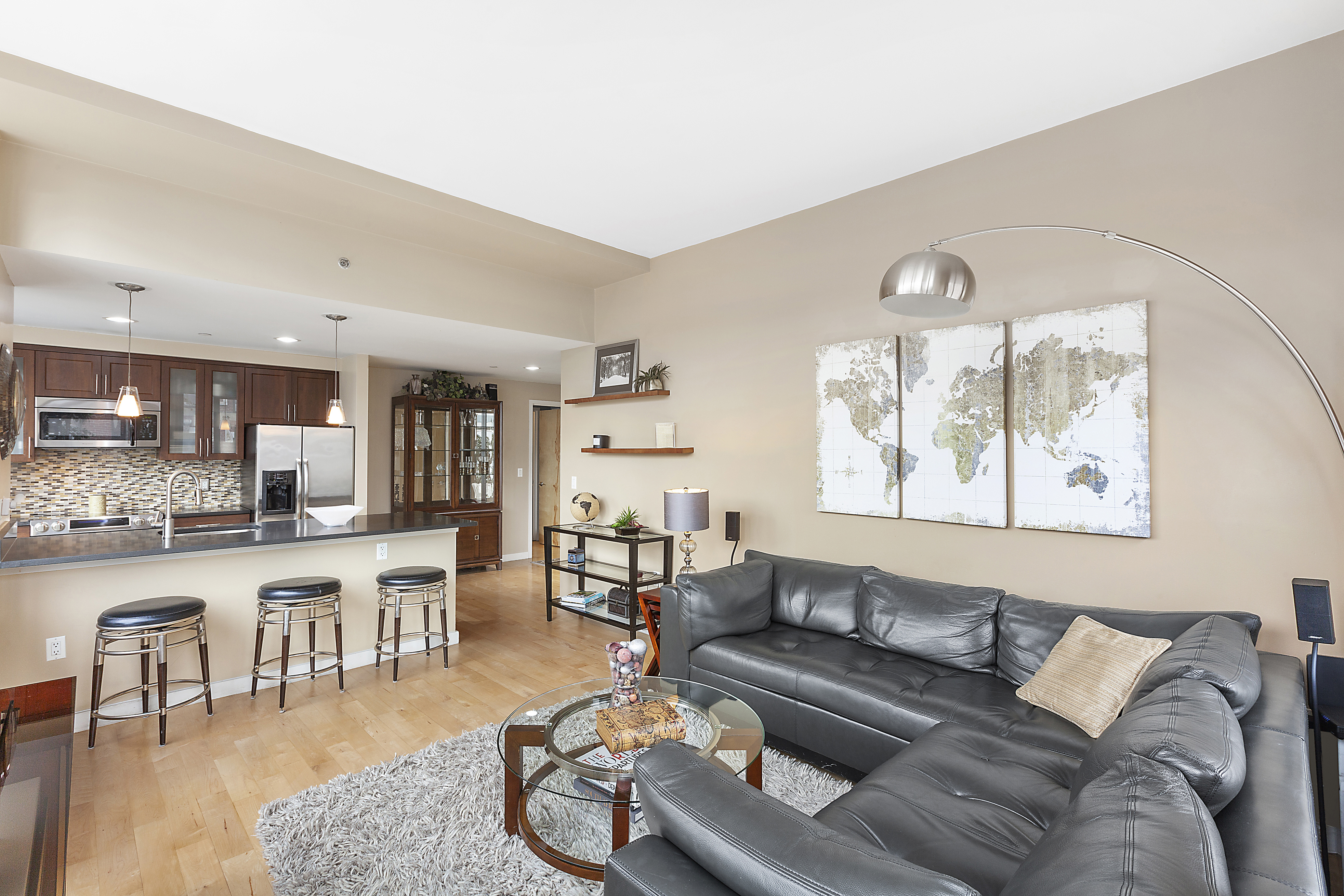 1595 Lexington Avenue, Unit 6E Manhattan, NY 10029 - Photo 2 of 13 a living room with furniture kitchen view and a wooden floor