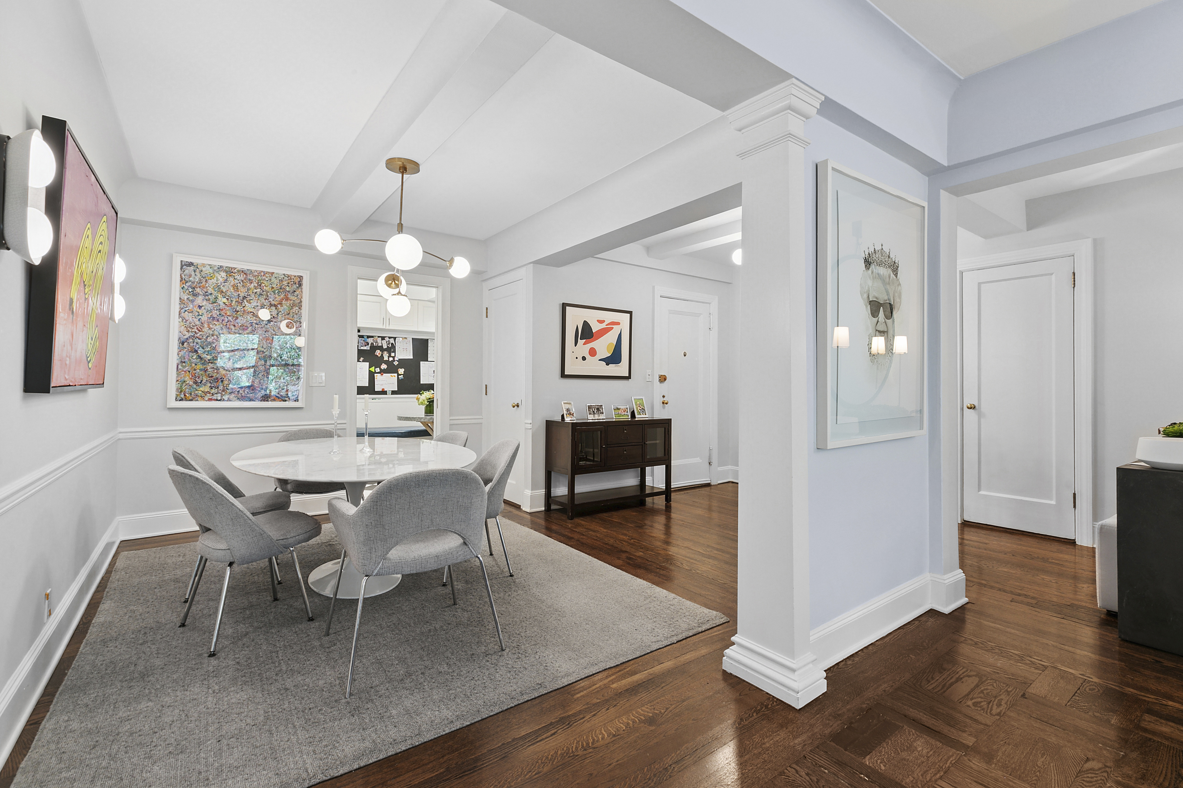 205 East 69th Street, Unit 3A Manhattan, NY 10021 - Photo 3 of 11 a dining room with wooden floor and chandelier