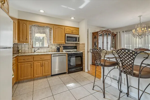 a kitchen with cabinets and chairs