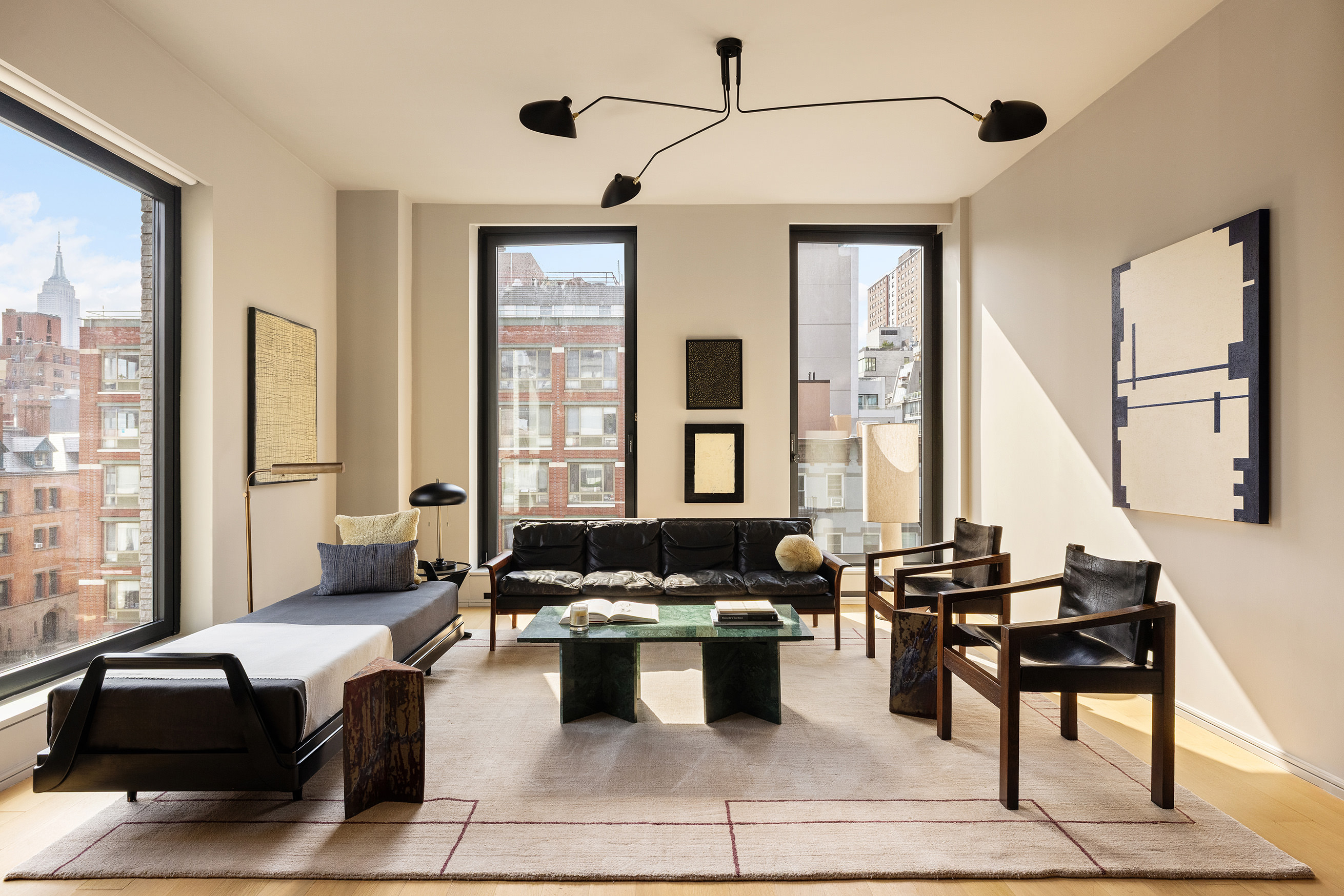 a living room with furniture and large windows