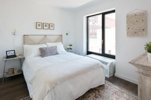 a bedroom with a bed and a window