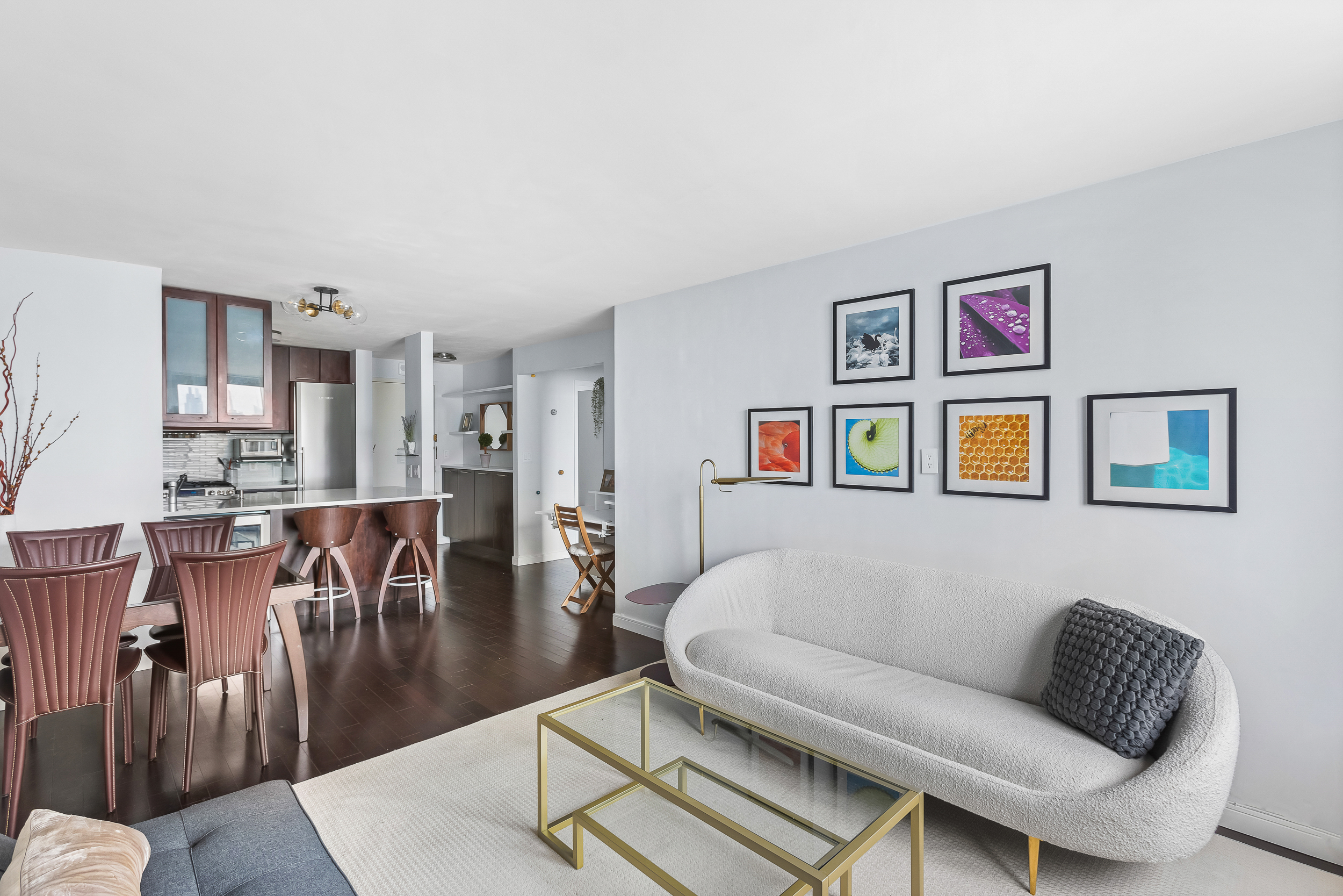 376 Broadway, Unit 14E Manhattan, NY 10013 - Photo 2 of 11 a living room with furniture and a dining table with wooden floor