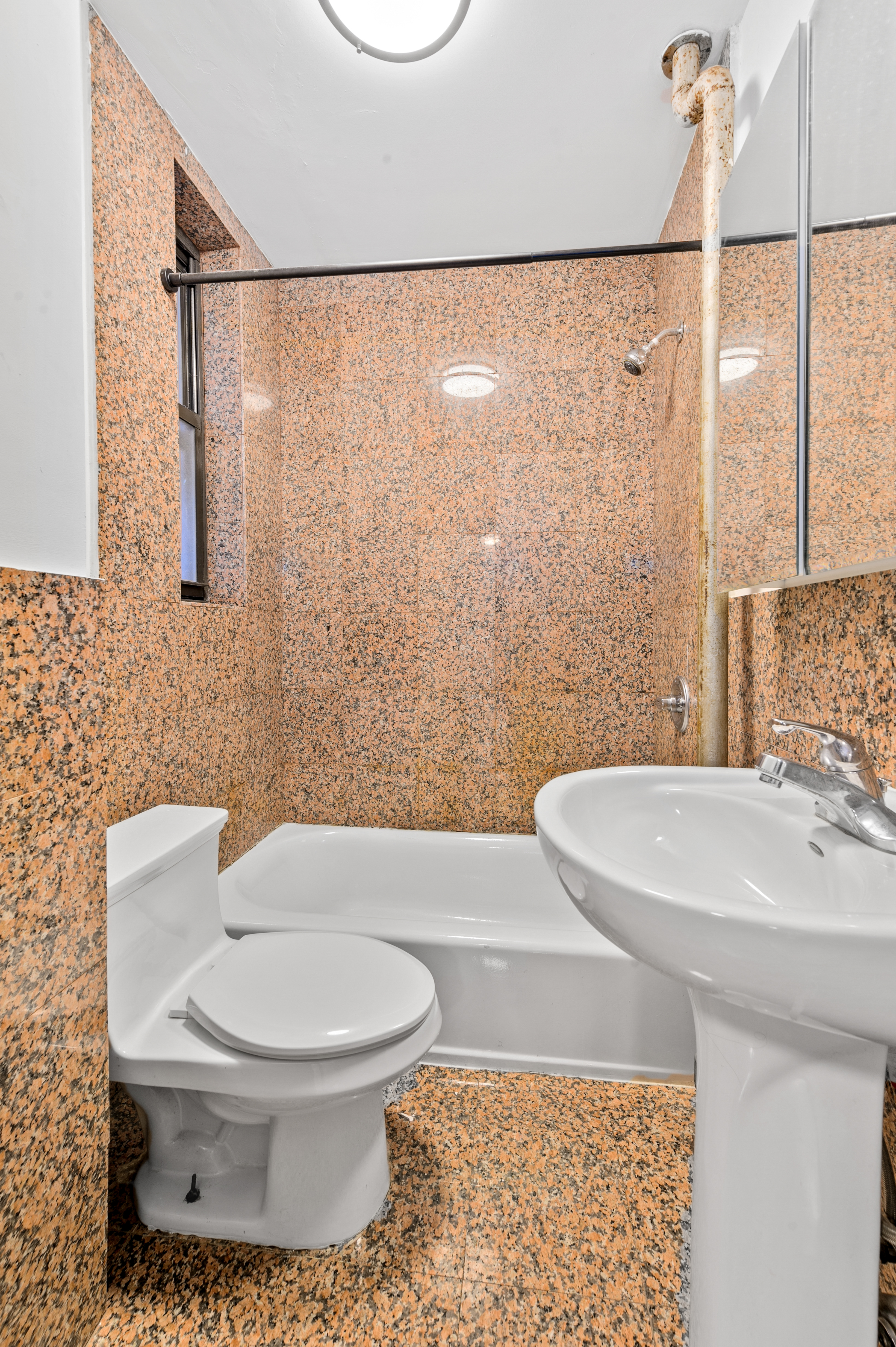 112 East 97th Street, Unit 4W Manhattan, NY 10029 - Photo 5 of 5 a white toilet sitting next to a bathroom sink