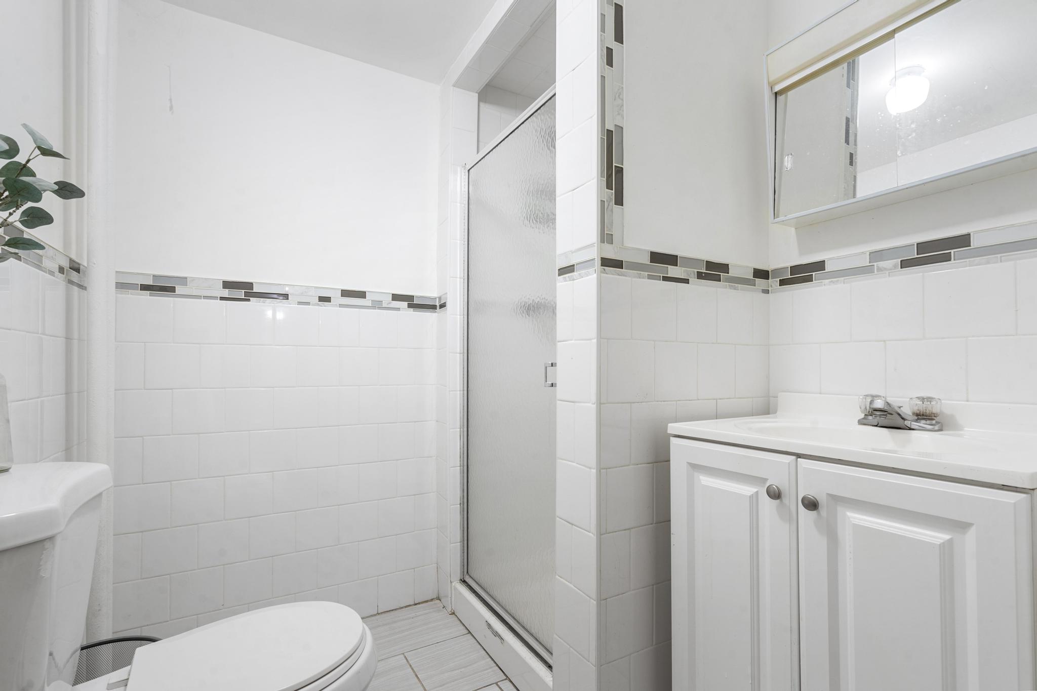 364 Clermont Avenue Brooklyn, NY 11238 - Photo 8 of 18 a bathroom with a sink a toilet a mirror and shower