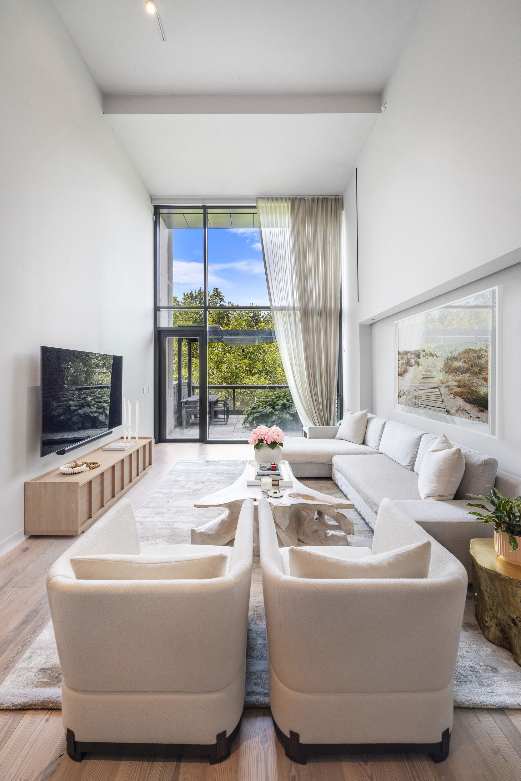 90 Furman Street, Unit N208 Brooklyn, NY 11201 - Photo 4 of 23 a living room with furniture and a flat screen tv