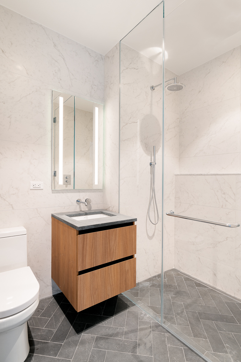 128 West 23rd Street, Unit 7C Manhattan, NY 10011 - Photo 4 of 5 a bathroom with a sink and a mirror