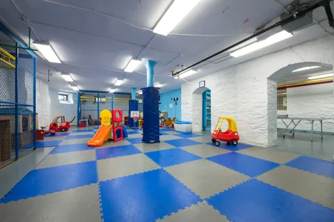 a view of a lake with a yard and large trees