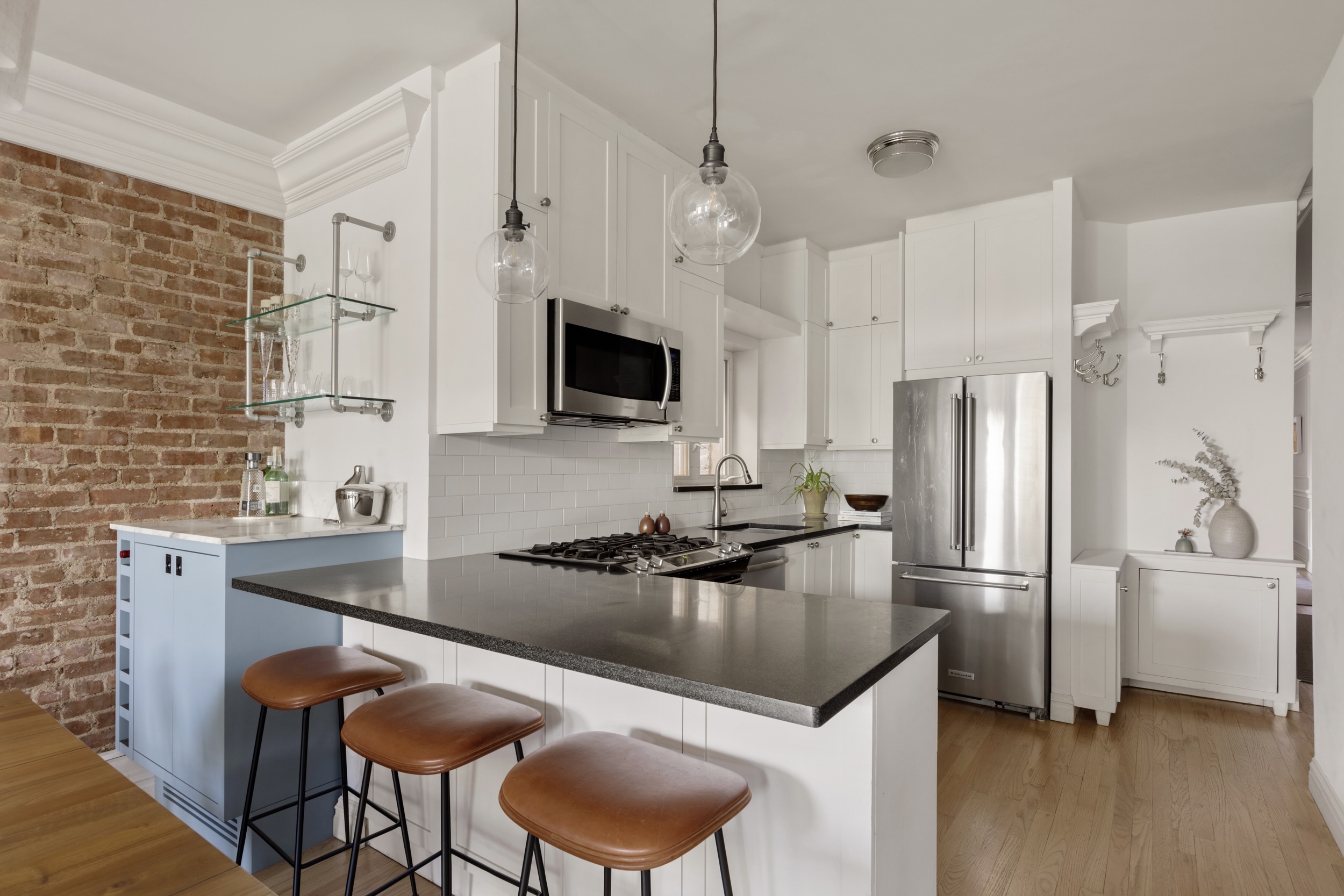 209 Clinton Street, Unit 4L Brooklyn, NY 11201 - Photo 7 of 17 a kitchen with stainless steel appliances granite countertop a sink refrigerator and microwave