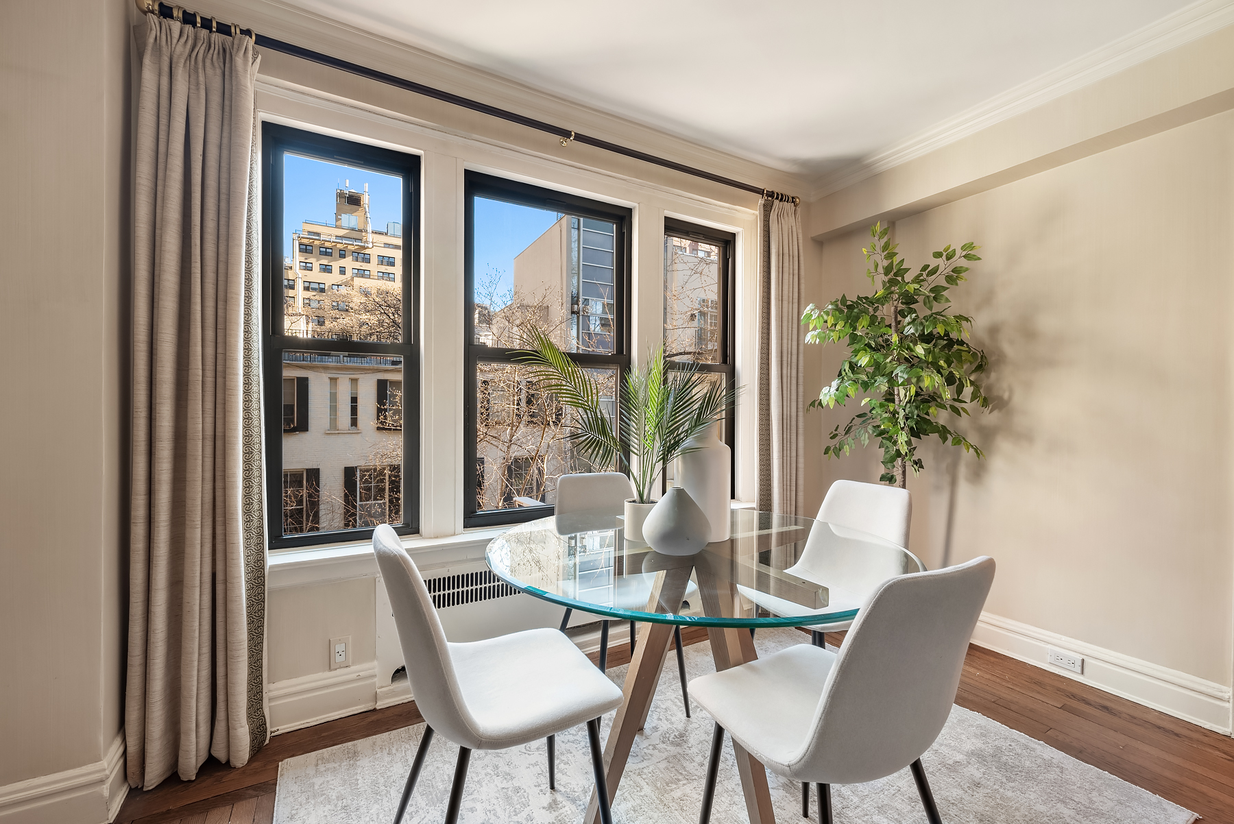 319 East 50th Street, Unit 4H Manhattan, NY 10022 - Photo 2 of 9 a view of a dining room with furniture window and wooden floor