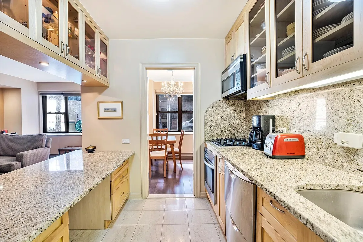a kitchen with stainless steel appliances granite countertop a sink and cabinets