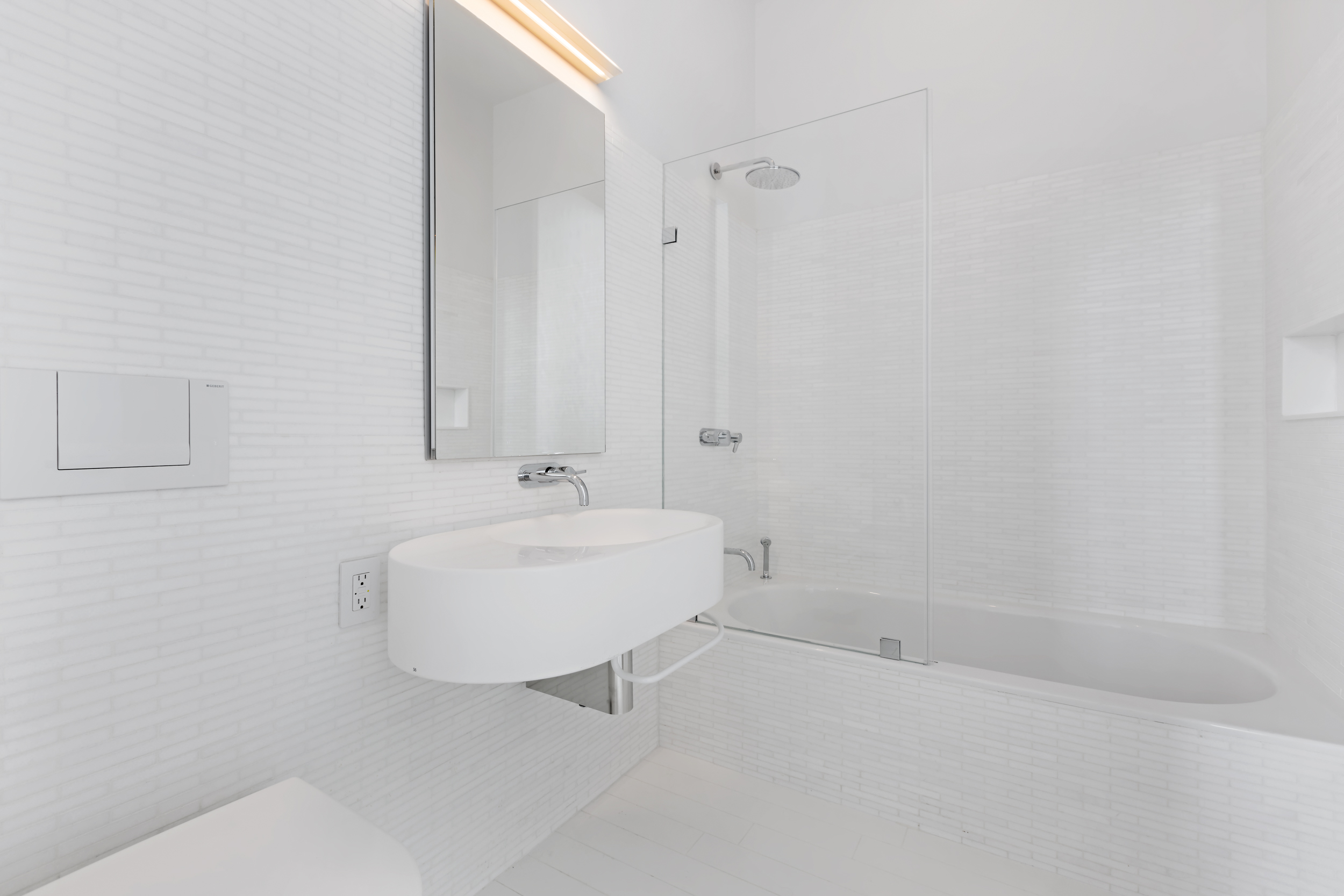 56 Leonard Street, Unit PH52A Manhattan, NY 10013 - Photo 19 of 24 a bathroom with a sink a toilet and shower