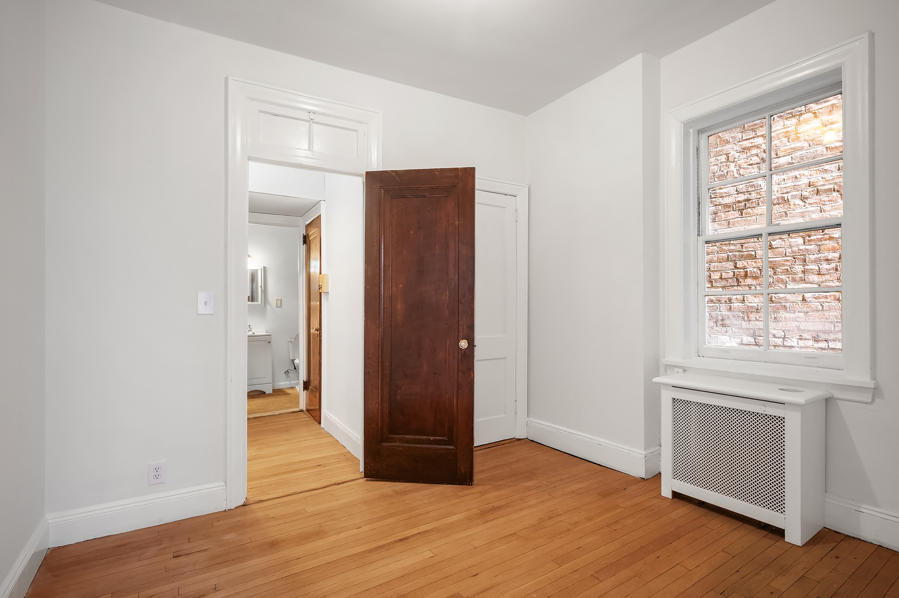 29 Perry Street, Unit 2F Manhattan, NY 10014 - Photo 10 of 17 an empty room with wooden floor and windows