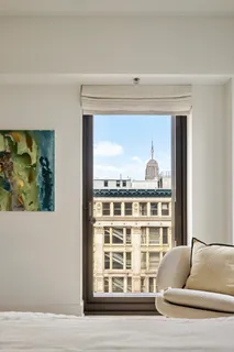 a bedroom with furniture and a window