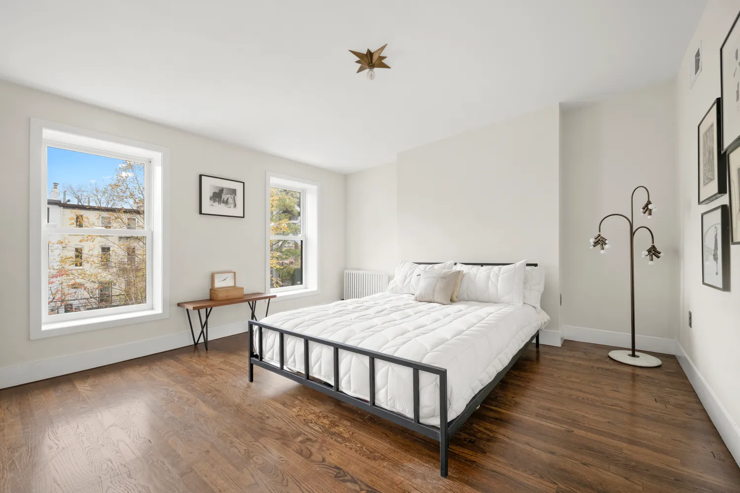 a bedroom with a bed window and a table