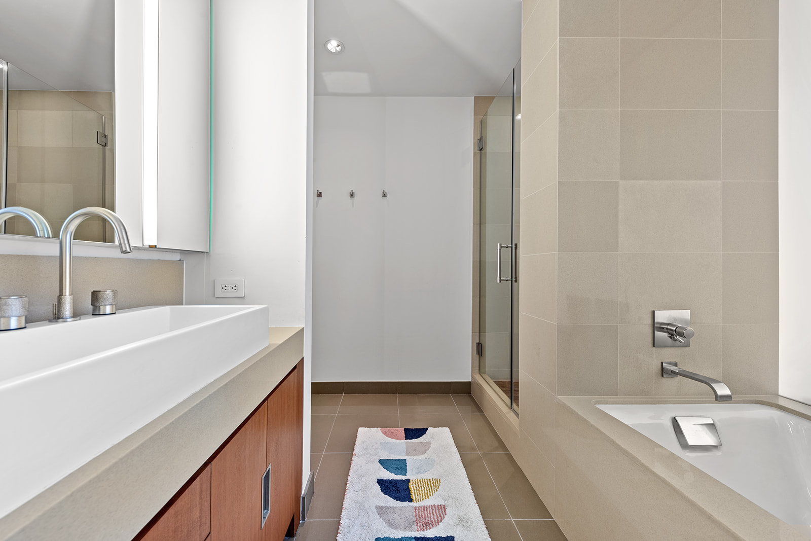 450 West 17th Street, Unit 2208 Manhattan, NY 10011 - Photo 6 of 8 a bathroom with a sink and a bathtub