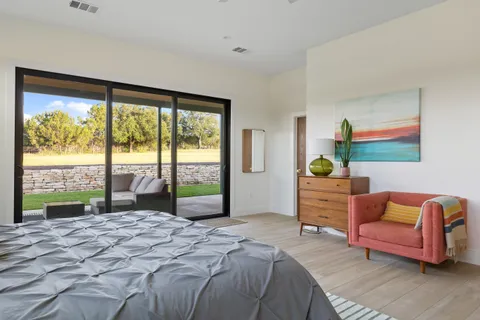a bedroom with a bed and a large window