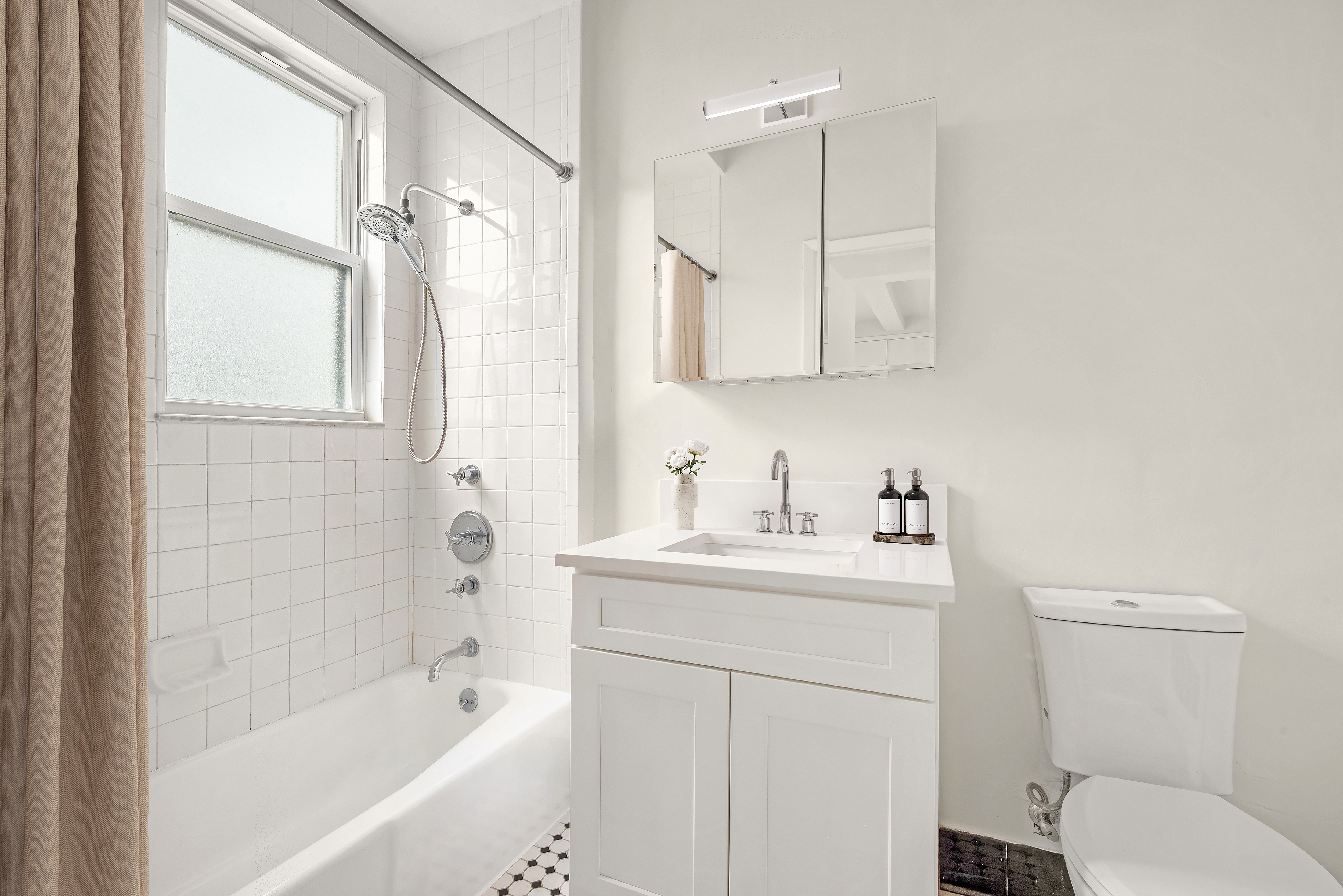 77 Park Avenue, Unit 16G Manhattan, NY 10016 - Photo 7 of 8 a bathroom with a sink a toilet and shower